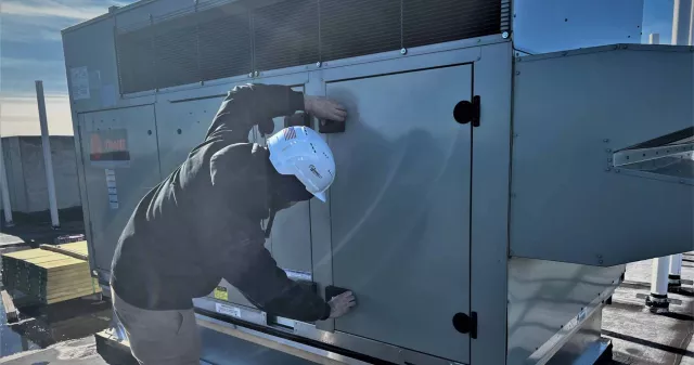 Donnelly Mechanical worker installing HVAC outside